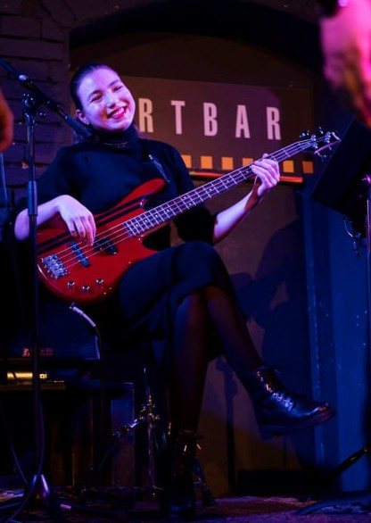 Playing bass guitar on stage
