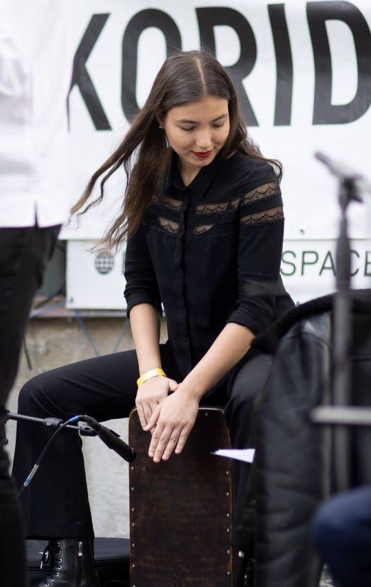 Playing cajon with a band at an outdoor concert