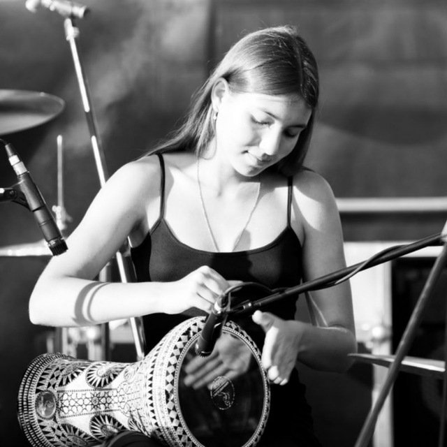 Playing darbuka on stage, black and white