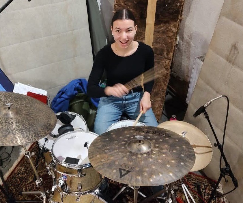 Playing drum set in a rehearsal studio
